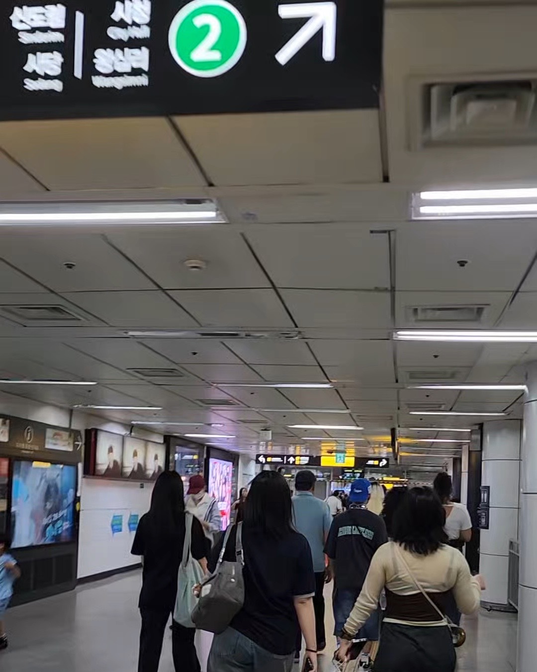 An overhead sign inside a Seoul subway station showing exit number 2 with a directional arrow.